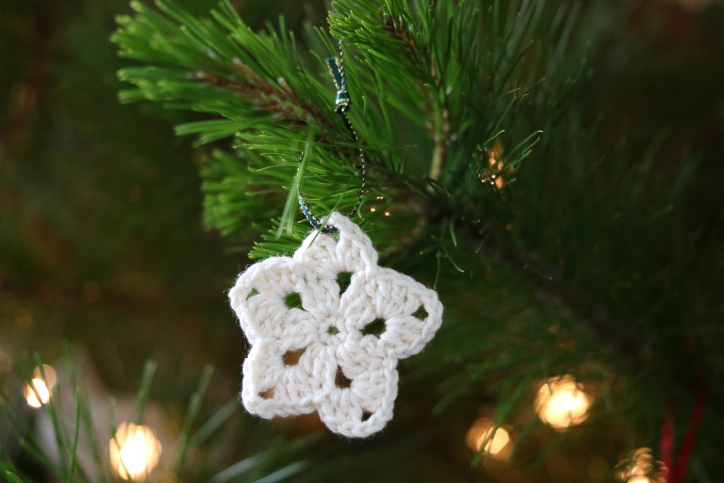 white cotton crochet Christmas star ornament with green & gold ribbon